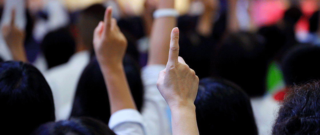 People holding up hands at auction