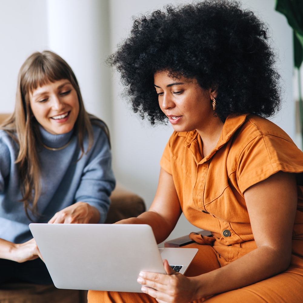 Two women evaluating Bloomerang nonprofit software